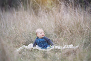 Baby photography outside in a field of grass